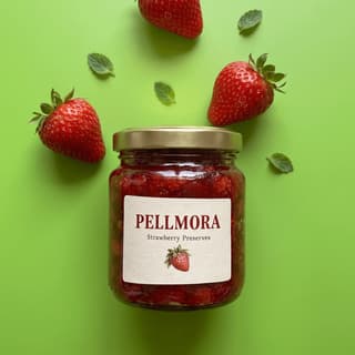Strawberry preserves jar with fresh berries on bright green — product launch poster photography