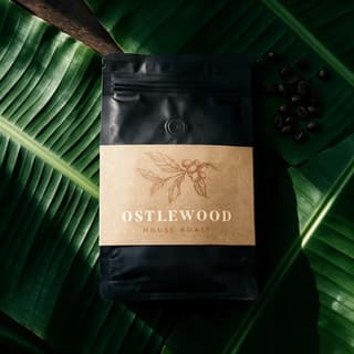 Whole-bean coffee bag on dark banana leaves — specialty coffee food photography