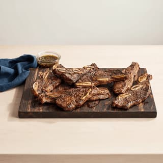 Asado de tira argentine short ribs cross cut char grilled coarse salt board — asado de tira hero photography