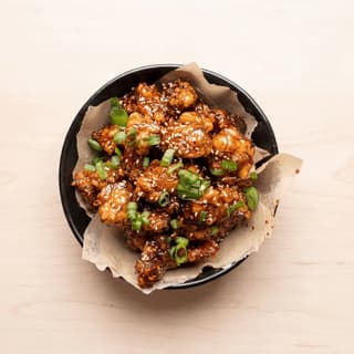 Modern asian fried chicken crispy glaze sesame scallion bun plate — asian fried chicken hero photography