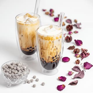 Bubble tea milk tea tapioca pearls tall glass layered gradient condensation — bubble tea hero photography