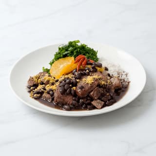Feijoada black bean stew smoked meats orange rice farofa bowl — feijoada hero photography