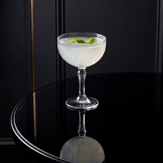 Daiquiri cocktail coupe glass lime twist crystal ice — craft cocktail hero photography