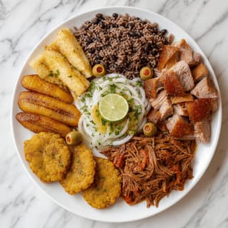 Cuban combo plate moros y cristianos rice beans roast pork yuca overhead marble — cuban plate hero photography