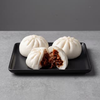 Char siu bao steamed bun split open red BBQ pork filling — Cantonese steamed bun hero photography