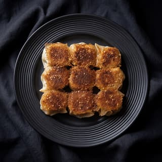 Crispy pan fried potstickers golden brown bottoms sesame seeds — Cantonese pan-fried dumpling hero photography