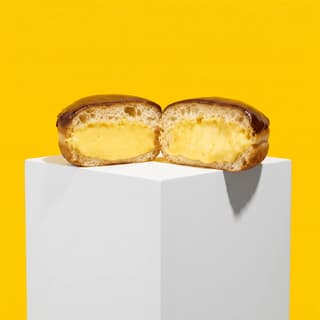 Boston cream filled donut split open custard chocolate top — filled donut hero photography