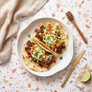 Korean short rib taco with kogi slaw and salsa roja on corn tortillas