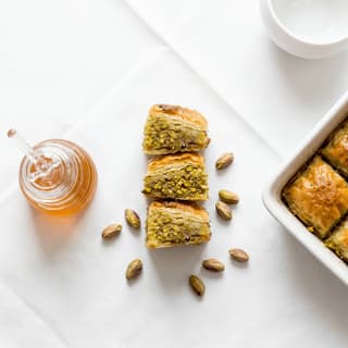 Baklava diamond phyllo layers pistachio honey syrup walnut tray macro — baklava hero photography