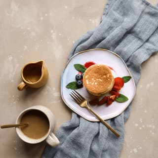 Moroccan baghrir thousand-hole pancakes with argan honey — hotel breakfast buffet photography