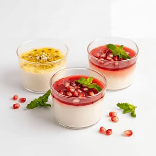 Malabi rosewater milk pudding red syrup pistachio coconut glass — Israeli malabi hero photography