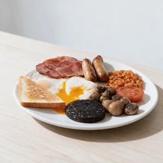 London full english breakfast runny yolk fried egg back bacon sausages beans black pudding grilled tomato — full english hero photography