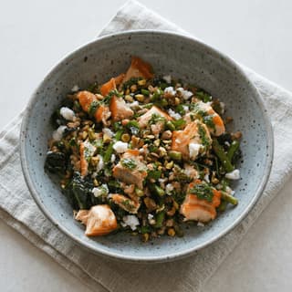 Mediterranean wellness bowl salmon greens farro avocado nuts overhead marble — wellness bowl hero photography