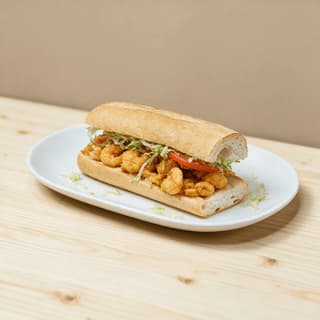 New orleans shrimp po boy crackly french bread fried gulf shrimp lettuce tomato remoulade — po boy hero photography