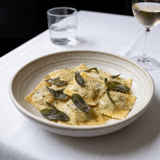 Fresh ricotta ravioli brown butter sage hand-pinched edges — Italian stuffed pasta hero photography