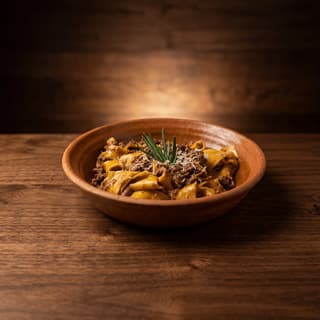 Pappardelle wild boar ragù wide ribbons rustic Tuscan pasta — slow-cooked hero photography