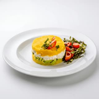 Causa rellena layered yellow potato avocado chicken pure shot — causa Peruvian hero photography