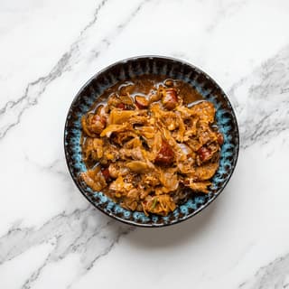 Bigos hunter stew sauerkraut meat mushroom rye bread overhead bowl — bigos hero photography