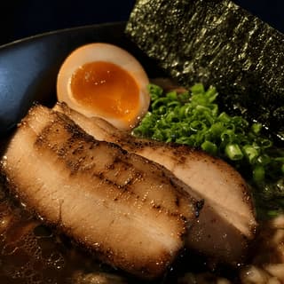 Chashu pork ajitama egg nori topping macro layered ramen — ramen toppings hero photography