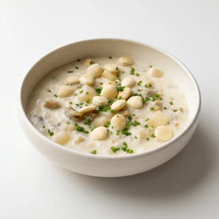 New England clam chowder bowl oyster crackers chives — seafood soup hero photography