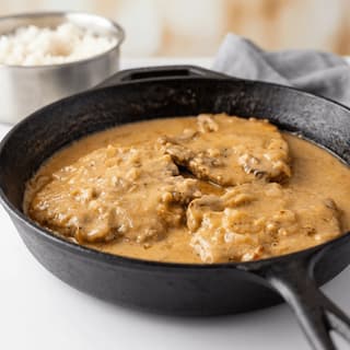 Smothered pork chops onion pepper gravy rice soul food plate — smothered chops hero photography