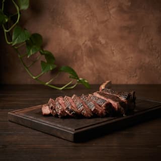 Tomahawk steak forty ounce bone in cutting board presentation — show cut hero photography