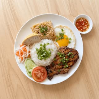 Com tam vietnamese broken rice grilled pork chop shredded skin egg scallion oil overhead plate — com tam hero photography