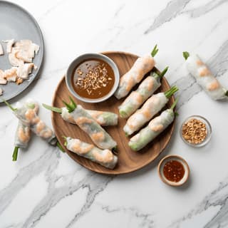 Goi cuon vietnamese fresh spring rolls translucent rice paper shrimp herbs peanut hoisin dip overhead — spring rolls hero photography