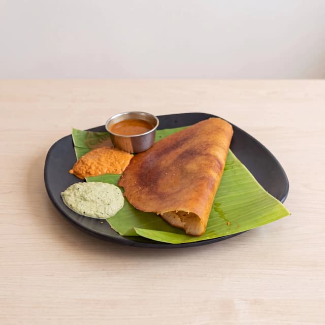 Masala dosa golden crispy roll sambar coconut chutney South Indian plate — dosa hero photography