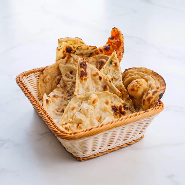 Naan basket butter charred bubbles garlic plain laccha bread overhead — naan hero photography