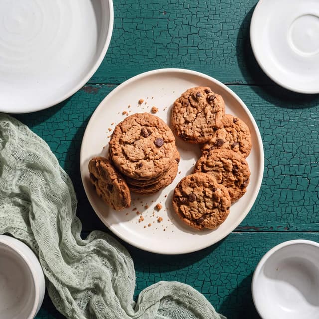 Chocolate chip cookies on teal crackle paint — custom backdrop food photography