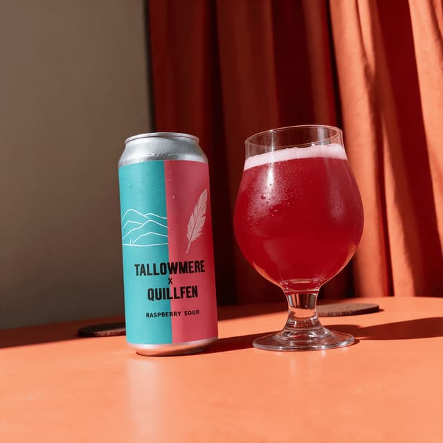 Collab sour can and raspberry pour on bold orange — collab release beer photography
