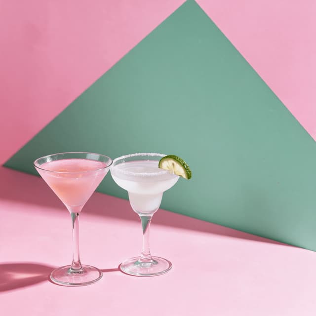 Happy-hour cocktails on a pink and sage color-block set — social media drink photography