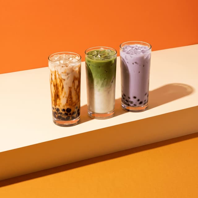 Brown sugar boba, iced matcha and taro tea on tangerine — bubble tea photography