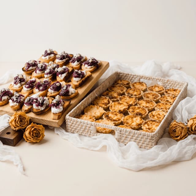 Crostini and mini quiches on cream with dried roses — custom template poster photography