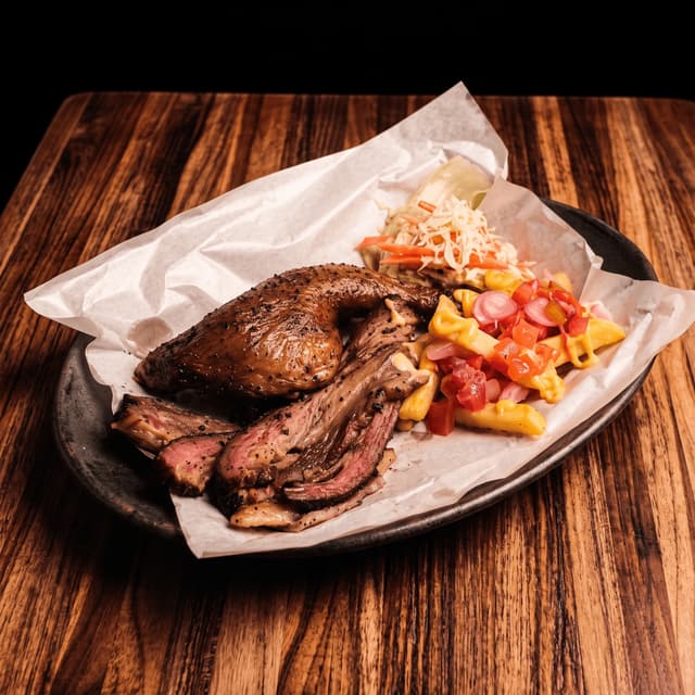 Smoked chicken and sliced brisket with cheese fries on parchment — BBQ truck flyer photography