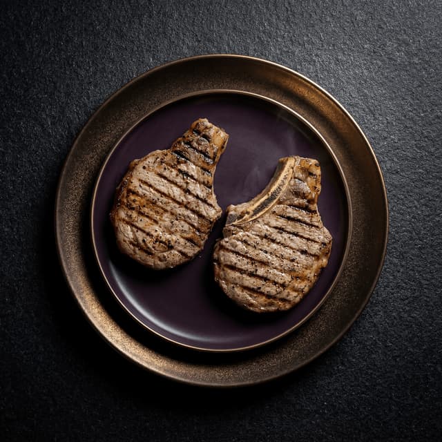 Argentine asado de tira cross-cut short ribs with coarse salt crust and char grill marks over wood embers — South American BBQ photography
