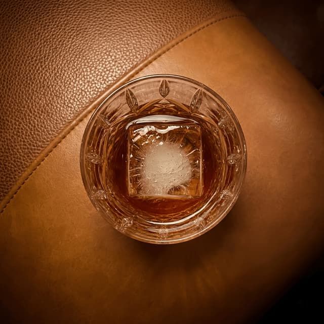 Bourbon whiskey lowball glass leather lounge crystal ice — whiskey lowball card photography