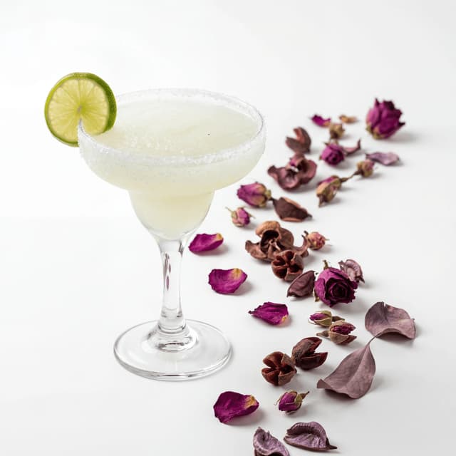 Frozen margarita tall glass salt rim lime swirl dallas tex-mex cocktail — margarita hero photography