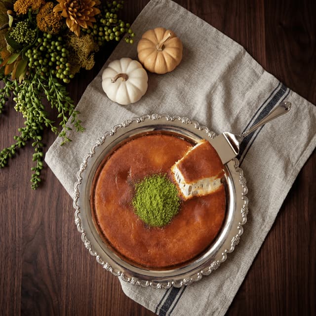 Jordanian knafeh with dramatic cheese pull, rose syrup and crushed pistachios on silver tray — traditional Middle Eastern dessert photography