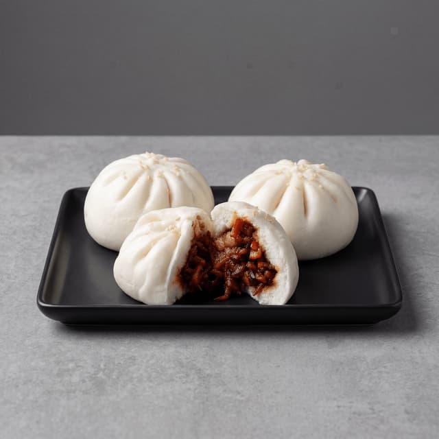 Char siu bao steamed bun split open red BBQ pork filling — Cantonese steamed bun hero photography