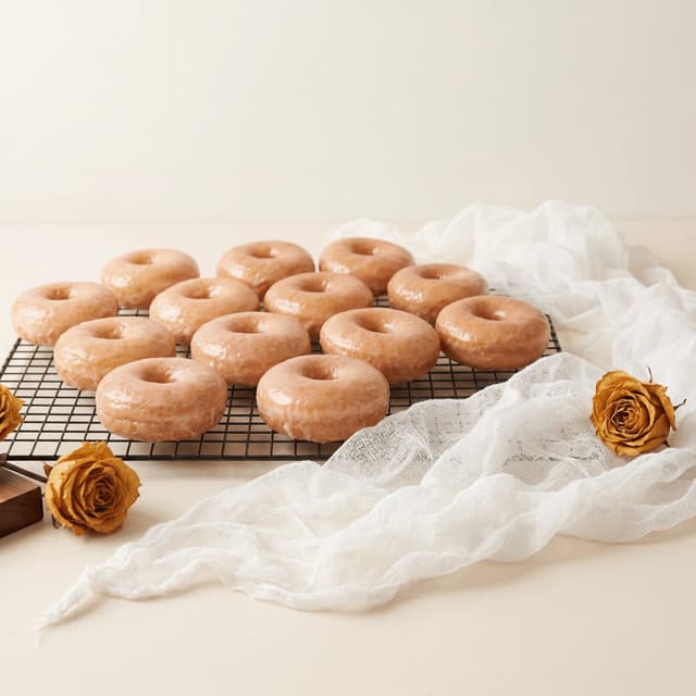 Classic glazed yeast donuts cooling rack pale honey amber — glazed donut card photography