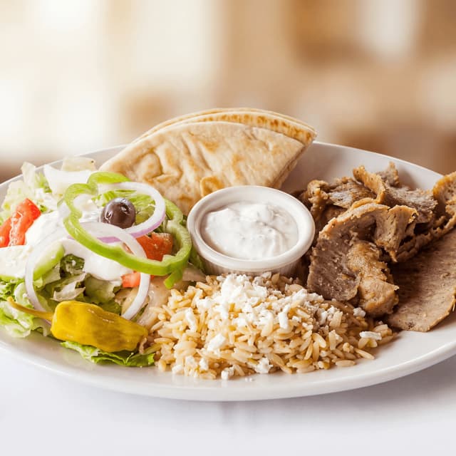Gyros plate shaved lamb pork pita tzatziki tomato onion fries — gyros hero photography