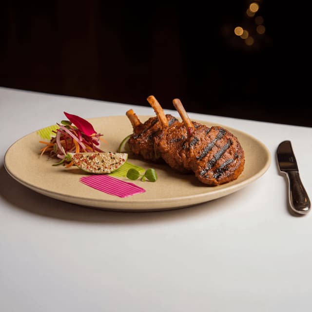 Herb-crusted rack of lamb with pommes dauphinoise — hotel banquet event food photography