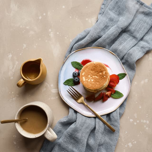 Moroccan baghrir thousand-hole pancakes with argan honey — hotel breakfast buffet photography