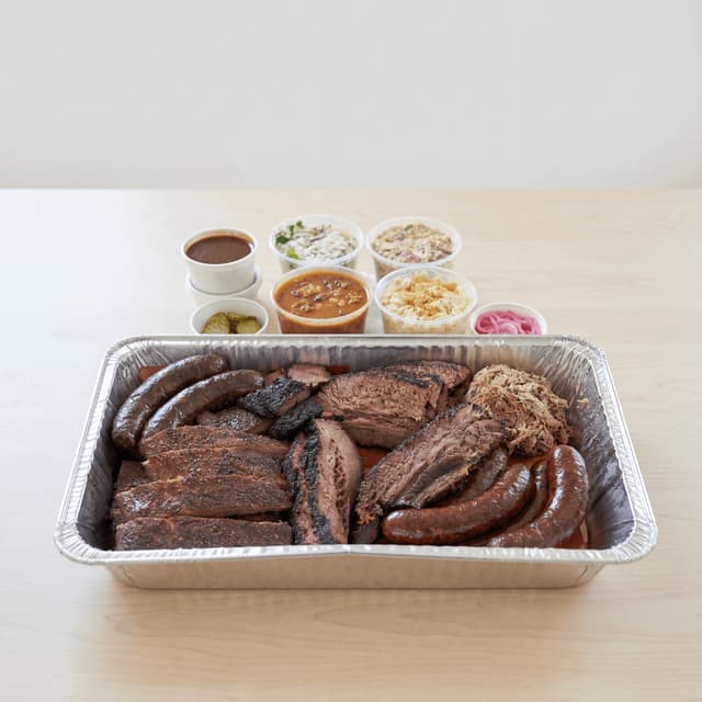 Houston BBQ-bræt med brisket, ribs, pølse, bagepapir, pickles og løg — BBQ-bræt-hero-fotografering