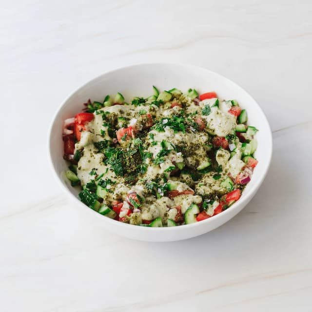 Israeli salad finely diced cucumber tomato parsley lemon bowl — Israeli salad hero photography