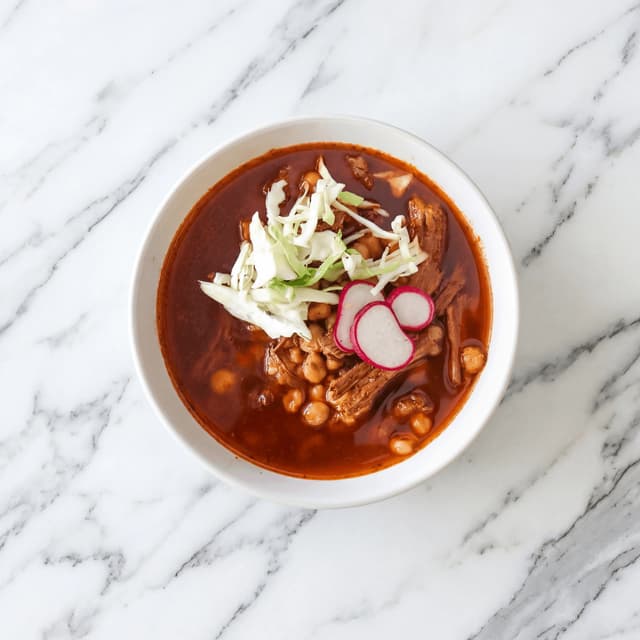 Pozole rojo hominy soup red broth radish cabbage lime oregano overhead bowl — pozole hero photography