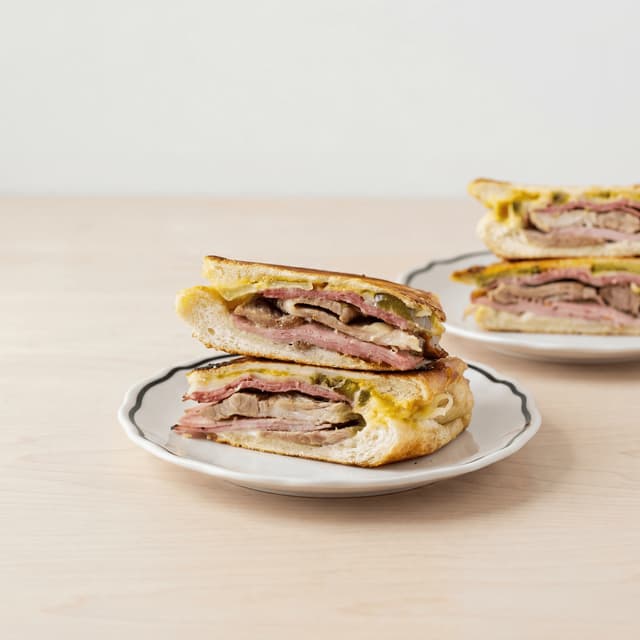 Cubano sandwich pressed cross section ham roast pork swiss pickle mustard miami — cubano hero photography