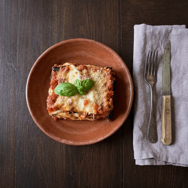 Eggplant lasagna parmigiana melanzane baked layers — Southern Italian pasta card photography